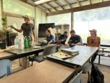 A man instructing four RAMP students in an outdoor classroom setting.